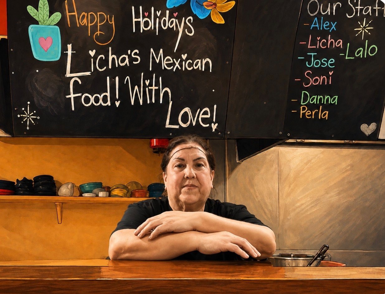 Licha standing at the counter of the kitchen, in front of a chalkboard that reads Licha's Mexican Food! With Love!